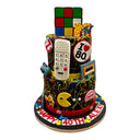 Custom three tier 80s themed cake with a Rubik's Cube and retro arcade decorations