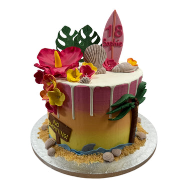 Custom 18th birthday beach cake with a fondant surfboard, flowers, shells and edible sand