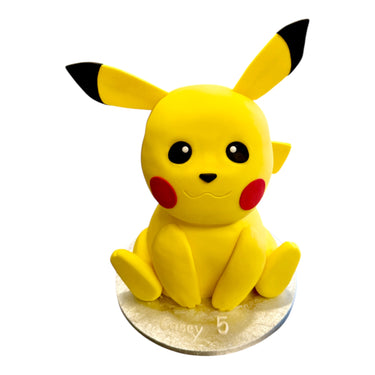 Custom Cake featuring a Pikachu design with yellow fondant, black-tipped ears, and red cheeks, personalized with Casey and number 5 on a silver cake board.