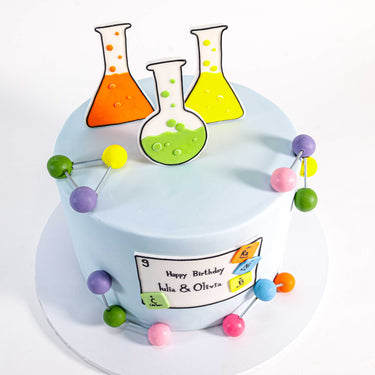 Science Cake with fondant chemistry decorations, biscuit flasks and molecule models