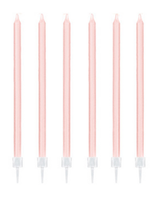 Six blush pink taper cake candles with white holders