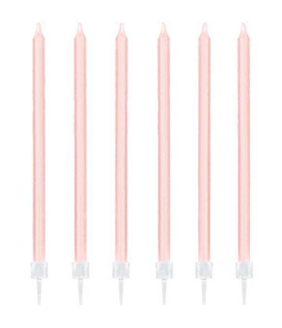 Six blush pink taper cake candles with white holders