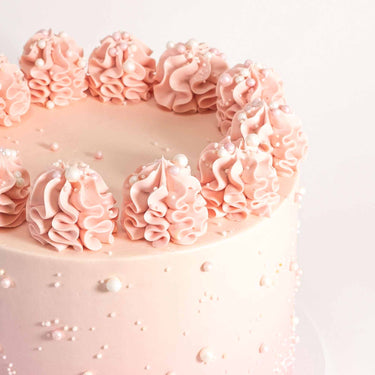 8 inch Ombré Cake with pink buttercream, piped ruffles, edible pearls and sprinkles