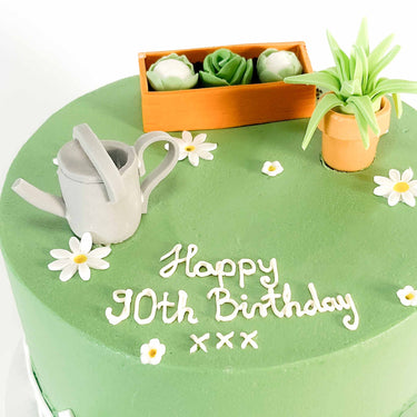 Gardening Cake with a fondant watering can, plant pots, planter and daisies, and a 90th birthday message