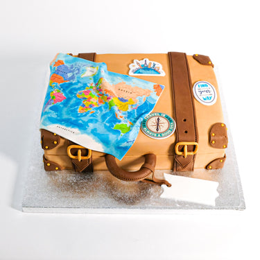 Vintage Suitcase Cake with fondant leather, a map and travel stickers on a silver board