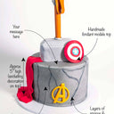 Free From Marvel Avengers Cake with labels showing the fondant hammer, shield, logo and message space