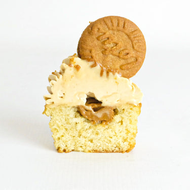 Biscoff Cupcake cut in half, showing a Biscoff spread centre, topped with Biscoff buttercream and a biscuit