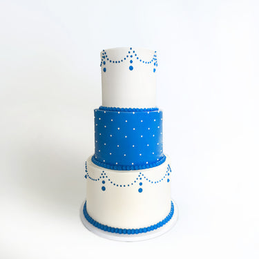 Three tier Formal Wedding Cake in white and blue icing with piped swags and dots