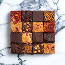 16 assorted brownies and blondies with different toppings