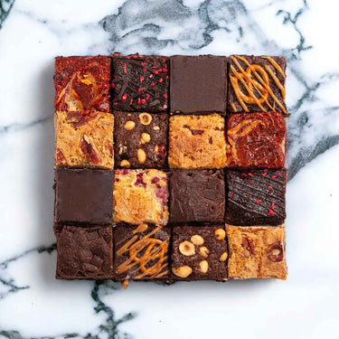 16 assorted brownies and blondies with different toppings