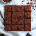 16 Chocolate Brownies topped with chocolate chunks, on marble