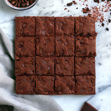 16 Chocolate Brownies topped with chocolate chunks, on marble