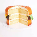 Cheeseburger Cake with labels showing the sponge buns, chocolate patty and vanilla layers