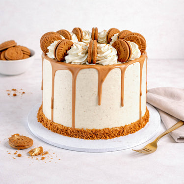 Lotus Biscoff Cake with Biscoff buttercream, caramel drip and Biscoff biscuits on a white cake board