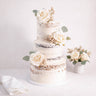Three tier Naked Wedding Cake with a semi naked buttercream finish, ivory roses and eucalyptus