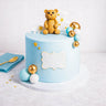 Teddy Bear Cake with a fondant bear, clouds, stars, gold and turquoise balls and a plaque