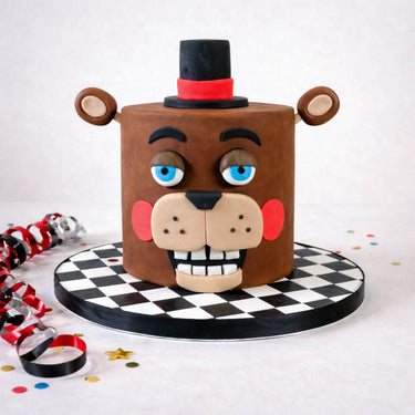 Five Nights at Freddy's Cake shaped as a cartoon bear's head, on a chequered board