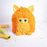 Furby Cake with orange buttercream fur and fondant ears, eyes, beak and feet