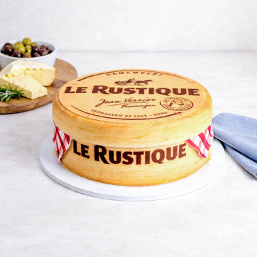 Cheese Cake, a sponge cake made to look like a round of Camembert, next to a cheese board