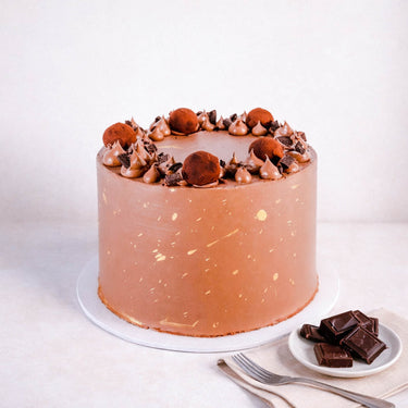 Free From Triple Chocolate Cake with milk chocolate buttercream, gold splatters, chocolate chunks and truffles