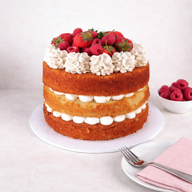Free From Victoria Sponge Cake with three layers of sponge, buttercream, strawberries and raspberries