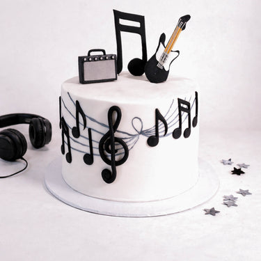 Music Cake with fondant music notes, a treble clef, a guitar and an amp