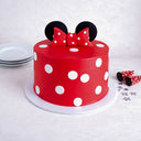 Minnie Mouse Cake in red with white polka dots, a fondant bow and black ears