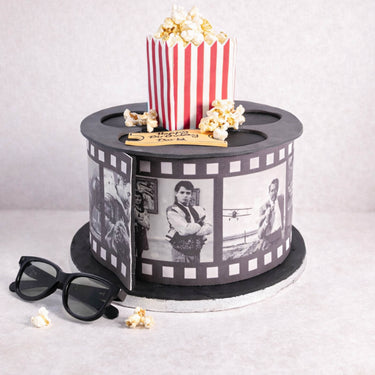 Movie Cake designed as a film reel, with a popcorn box, 3D glasses and fondant film strip