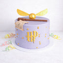 Free From Harry Potter Cake in purple with a golden snitch, wand, parchment and gold stars