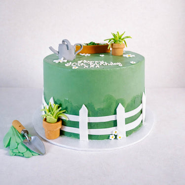 Gardening Cake with a fondant picket fence, garden tools and succulents