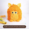 Gluten friendly Free From Furby Cake with orange buttercream fur, big eyes and fondant ears, with confetti