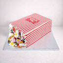 Sweety Box Cake made to look like a tipped over sweet bag, with colourful sweets spilling out