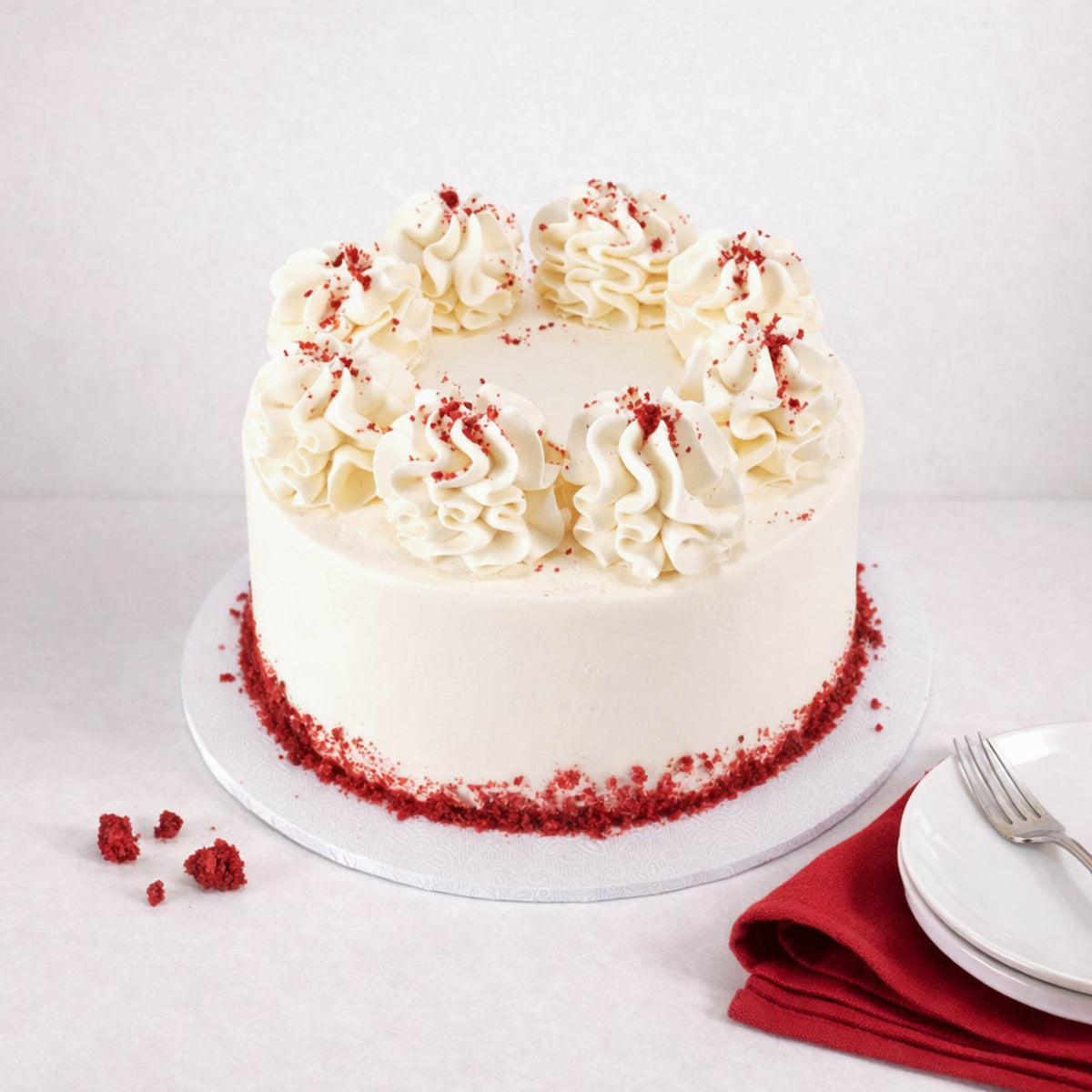 Mini Red Velvet Cake with piped buttercream swirls and red velvet crumbs