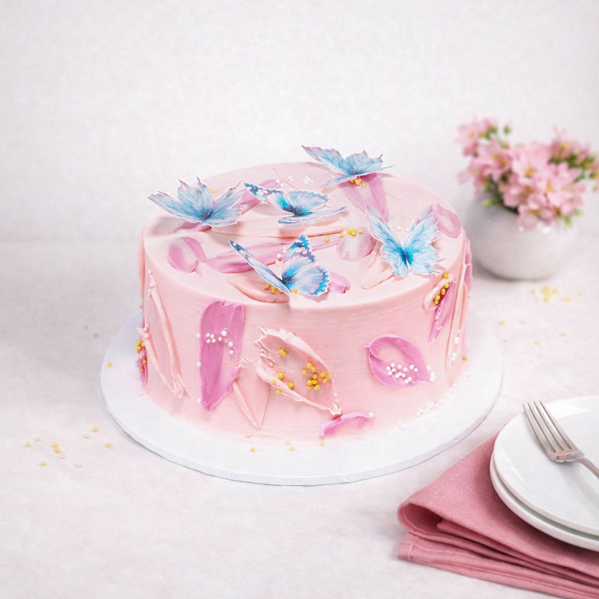Mini Butterfly Cake with pink buttercream swirls, sugar pearls and edible butterflies