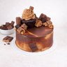 Mini Chocolate Overload Cake topped with a chocolate cupcake, broken chocolate bars and sweets
