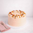 Mini Carrot Cake with pale peach buttercream, cream rosettes, honeycomb and edible petals