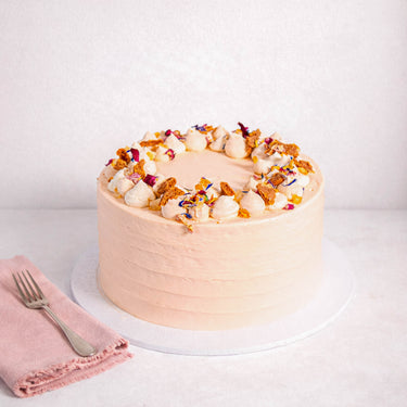 Mini Carrot Cake with pale peach buttercream, cream rosettes, honeycomb and edible petals