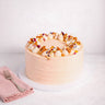 Mini Carrot Cake with pale peach buttercream, cream rosettes, honeycomb and edible petals