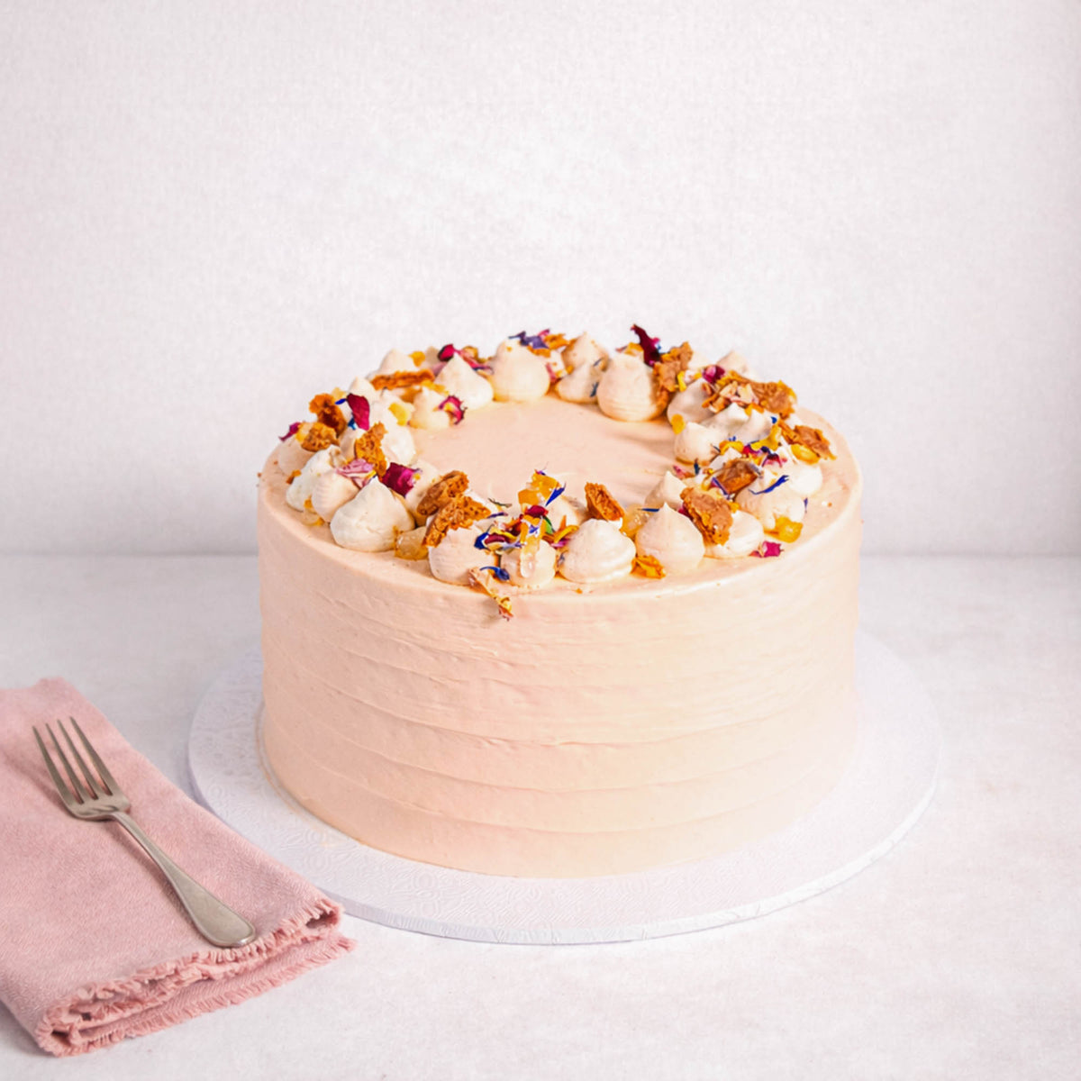 Mini Carrot Cake with pale peach buttercream, cream rosettes, honeycomb and edible petals