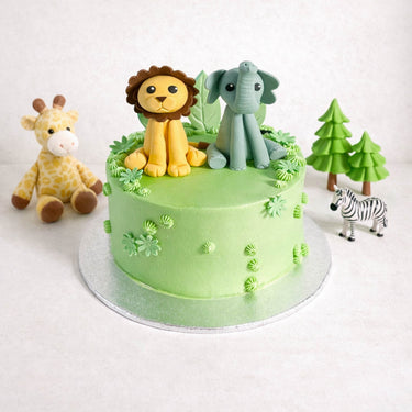 Mini Jungle Cake with a fondant lion and elephant on a silver cake board