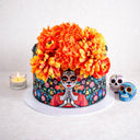 Day of the Dead Cake with a sugar skull lady design and marigold style flowers, with a tealight