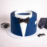 Suit Cake decorated as a dinner jacket, with navy fondant lapels, a black bow tie and buttons