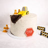 Digger Cake with a fondant digger and building site decorations on white buttercream