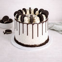 Oreo Cake with cookies and cream buttercream, chocolate drip, vanilla swirls and Oreo biscuits on top