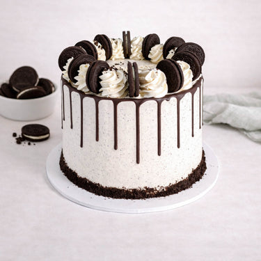 Oreo Cake with cookies and cream buttercream, chocolate drip, vanilla swirls and Oreo biscuits on top