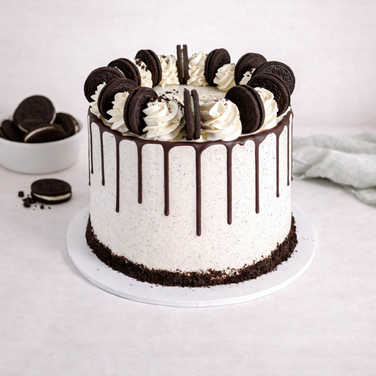 Oreo Cake with cookies and cream buttercream, chocolate drip, vanilla swirls and Oreo biscuits on top