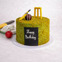 Cricket Cake decorated as a cricket pitch with an edible bat, ball and stumps and a happy birthday plaque