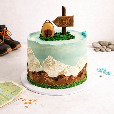 Hiking Cake with buttercream mountains, a fondant rucksack and signpost, made for a 50th birthday