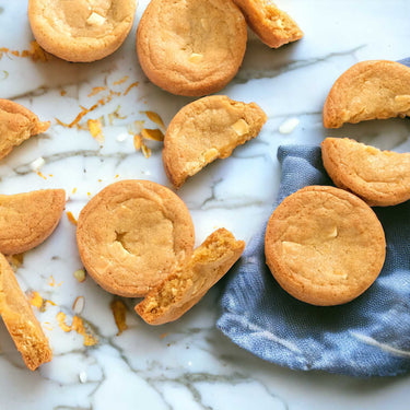 Lemon and White Chocolate Cookies with white chocolate chunks and zest, on marble