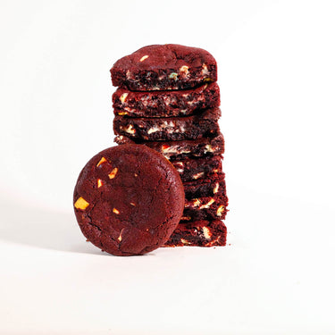 Stack of Red Velvet Cookies showing a soft centre and chocolate chips